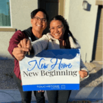 A smiling young couple celebrates purchasing their new Las Vegas townhome, holding a large "New Home, New Beginning" sign outside at a Touchstone Living neighborhood.